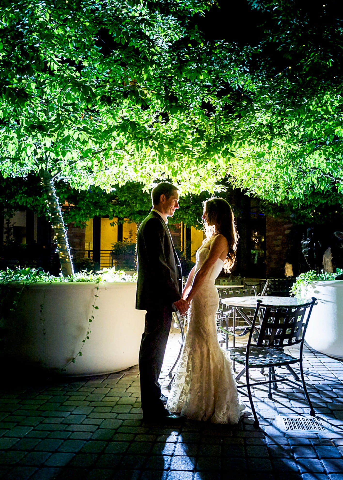Bride and groom holding hands on an outdoor patio