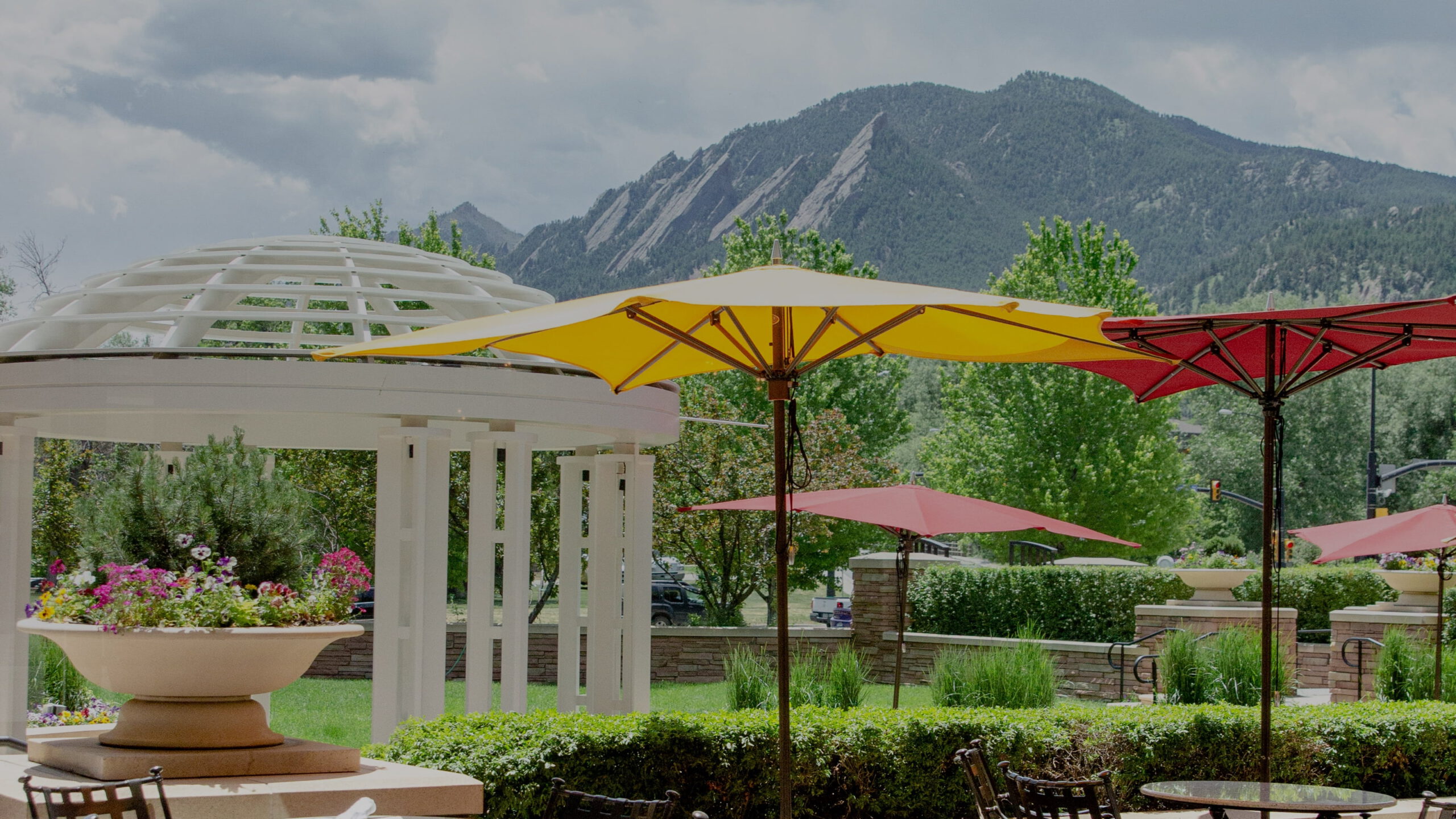 Outdoor seating and umbrellas against the mountains