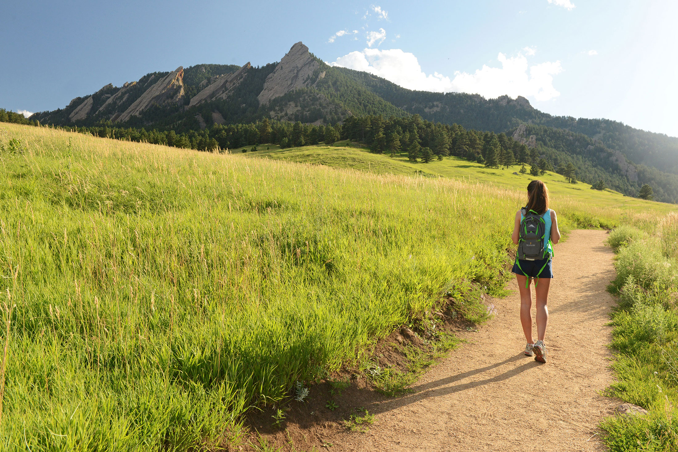 Woman walking with backpack hiking in Boulder CO