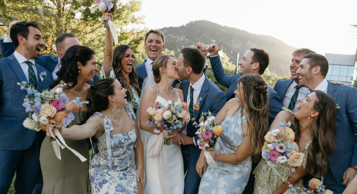 wedding kiss and celebration with the wedding party